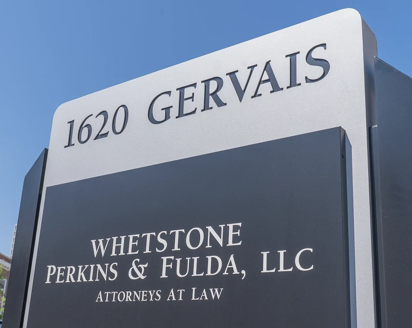 Outdoor sign displaying the address 1620 Gervais and the law firm name Whetstone Perkins & Fulda, LLC, Attorneys at Law